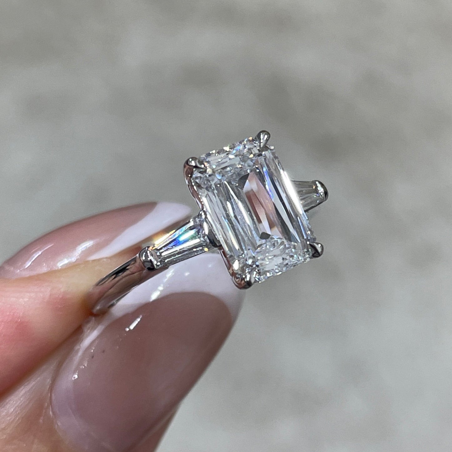 IGI Lab diamond Emerald criss cut 2.5ct with tapered baguette cut 0.3ct three stone ring