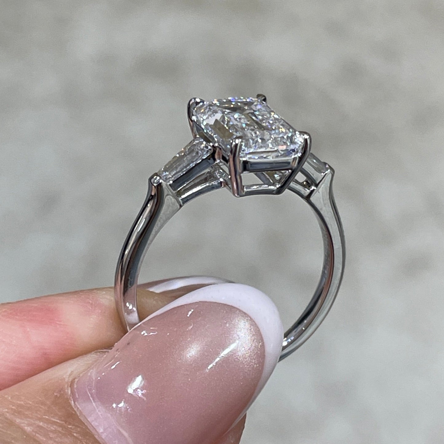 IGI Lab diamond Emerald criss cut 2.5ct with tapered baguette cut 0.3ct three stone ring
