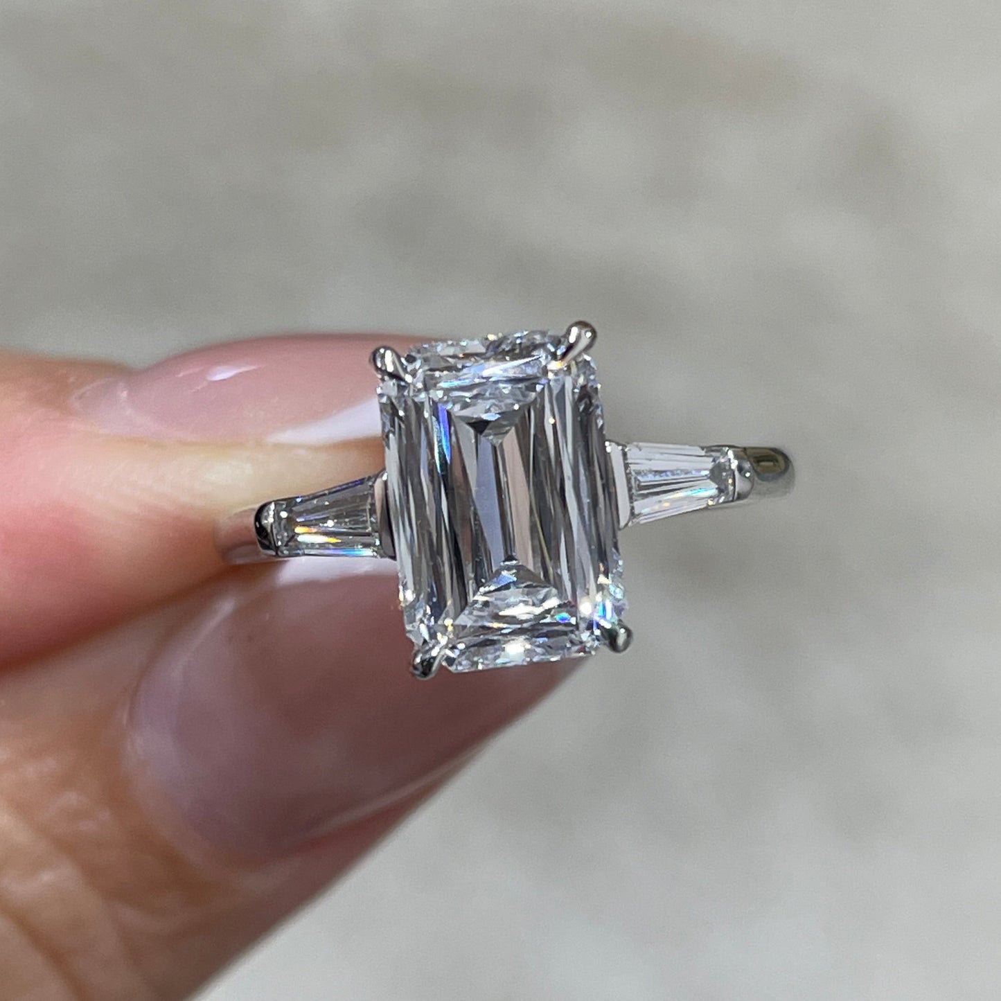 IGI Lab diamond Emerald criss cut 2.5ct with tapered baguette cut 0.3ct three stone ring