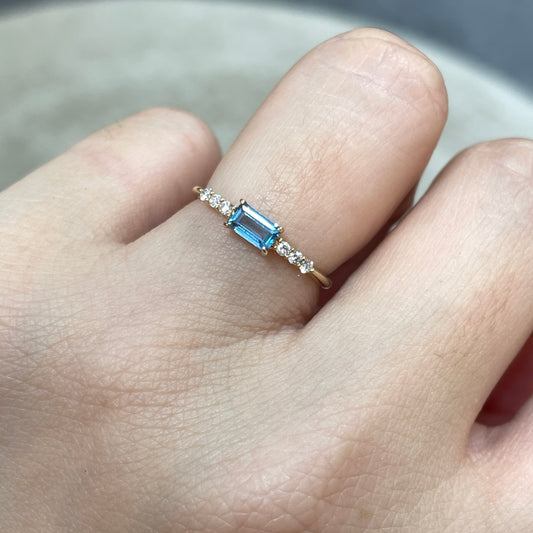 9k Lab sapphire aquamarine color baguette cut 0.35ct four-prong side stone ring
