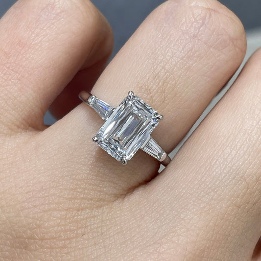 IGI Lab diamond Emerald criss cut 2.5ct with tapered baguette cut 0.3ct three stone ring