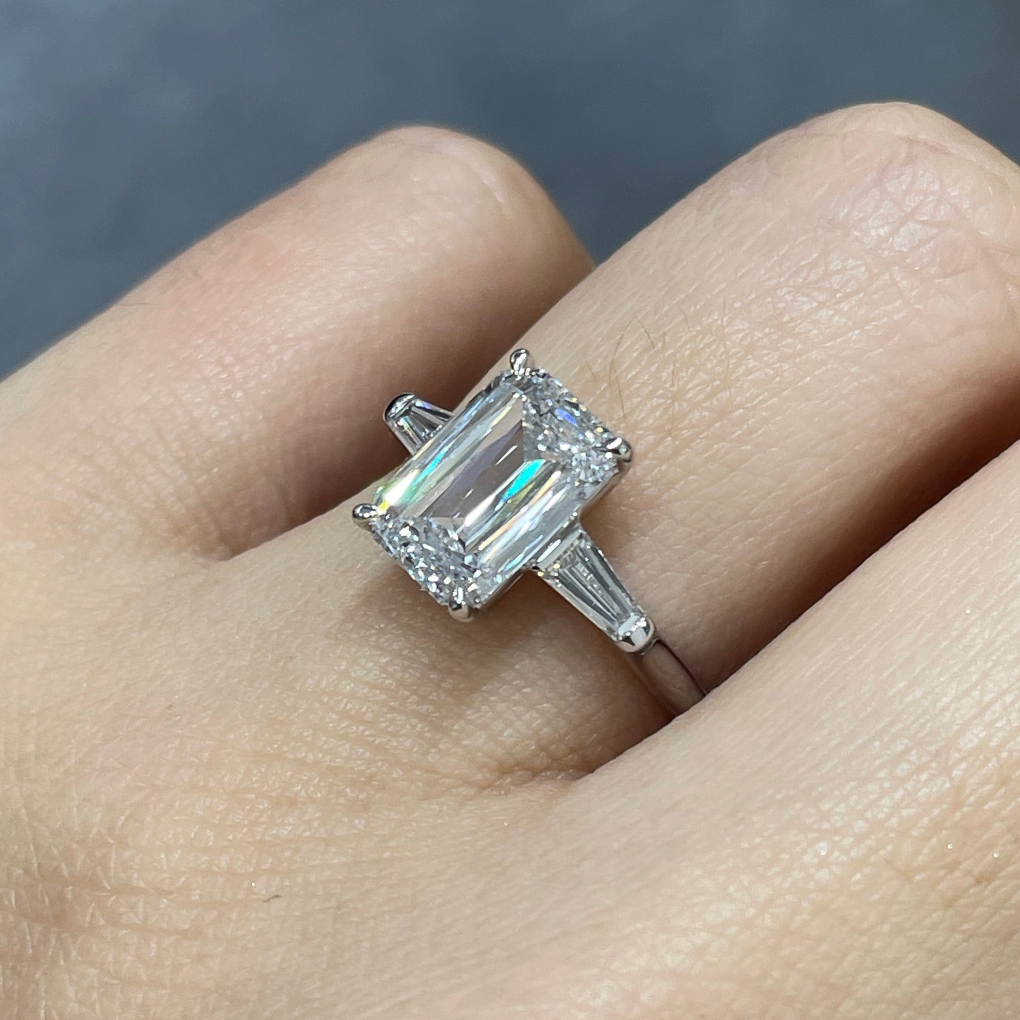 IGI Lab diamond Emerald criss cut 2.5ct with tapered baguette cut 0.3ct three stone ring