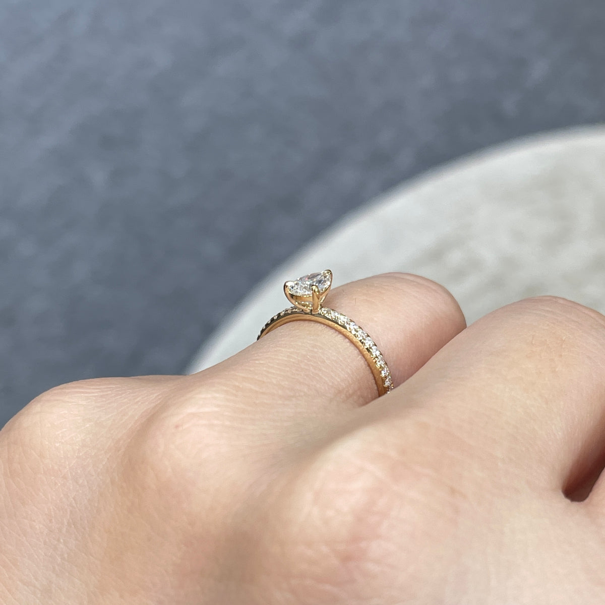 9k Lab diamond pear 0.6ct three-prong ¾ coverage pave ring