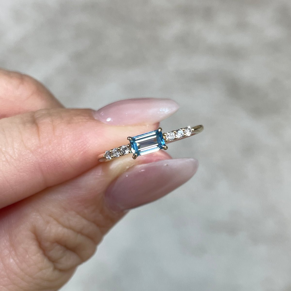 9k Lab sapphire aquamarine color baguette cut 0.35ct four-prong side stone ring