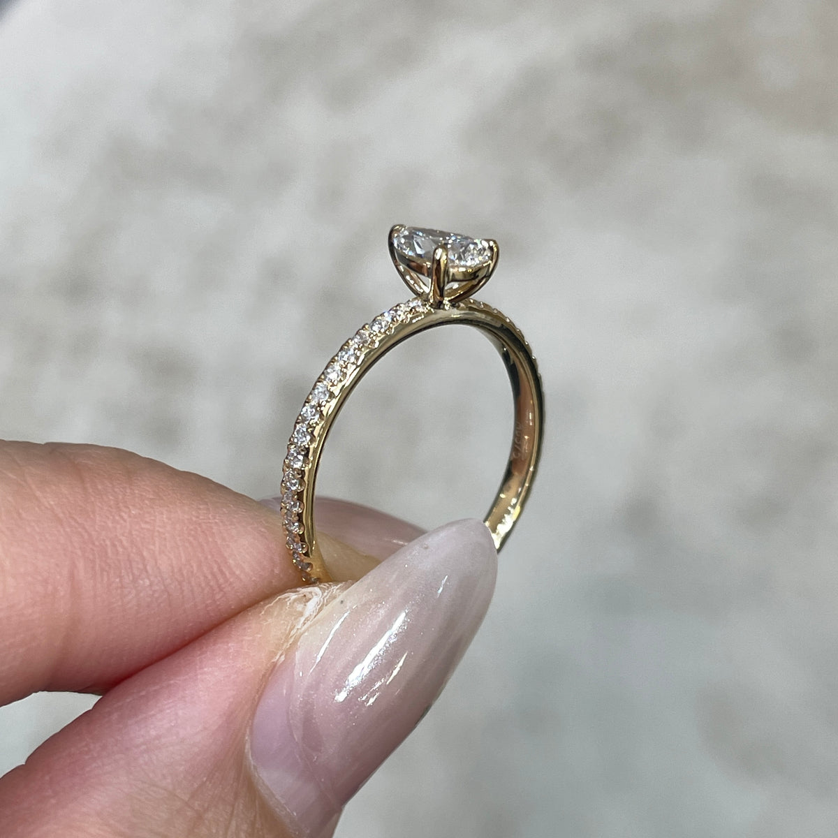 9k Lab diamond pear 0.6ct three-prong ¾ coverage pave ring