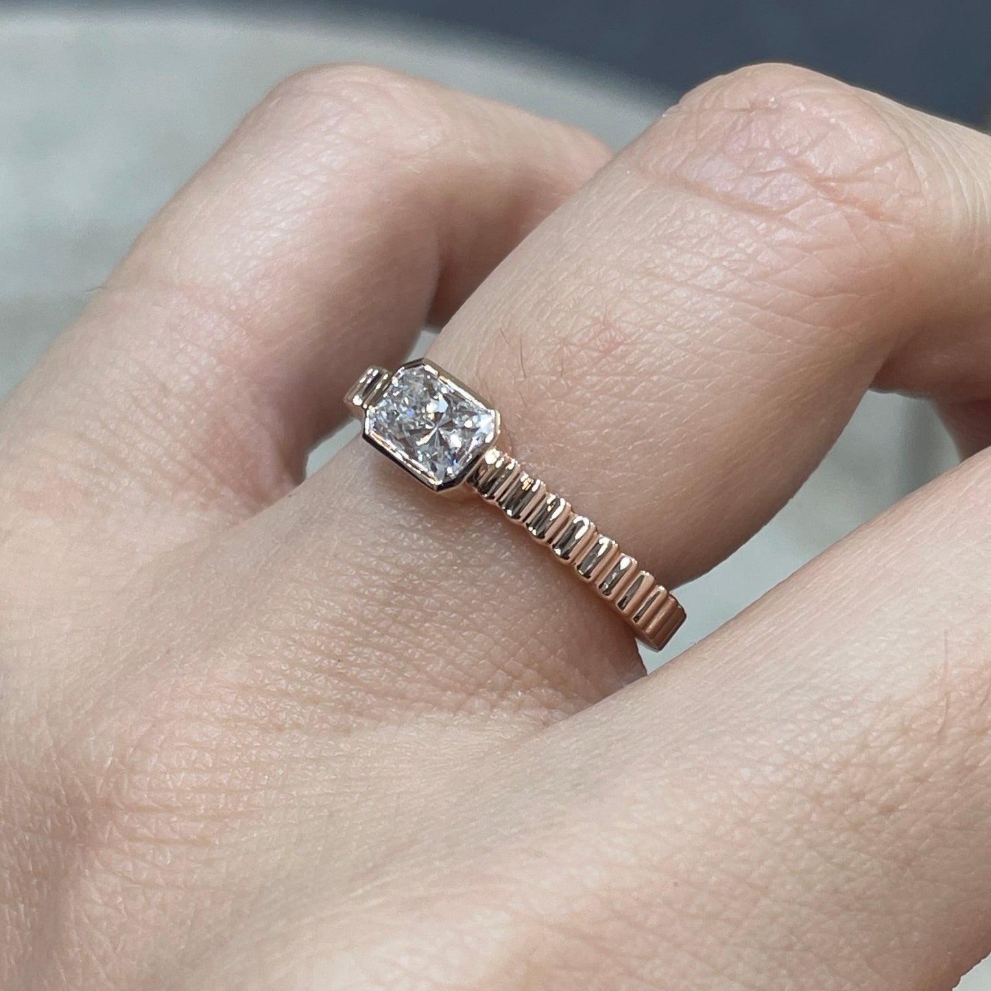 9k Lab diamond Radiant cut 0.6ct horizontal bezel set with vertical line band ring