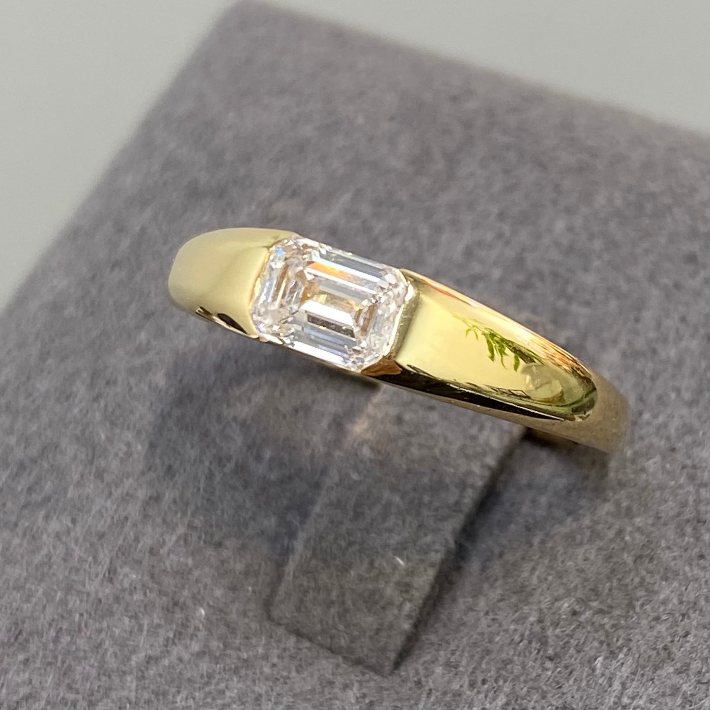 IGI Lab diamond emerald cut 0.6ct east west horizontal ring
