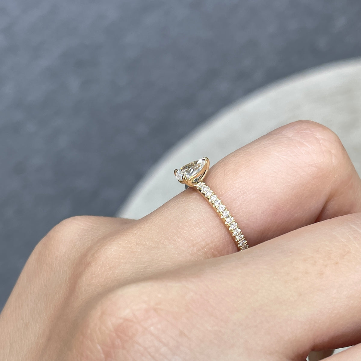 9k Lab diamond pear 0.6ct three-prong ¾ coverage pave ring
