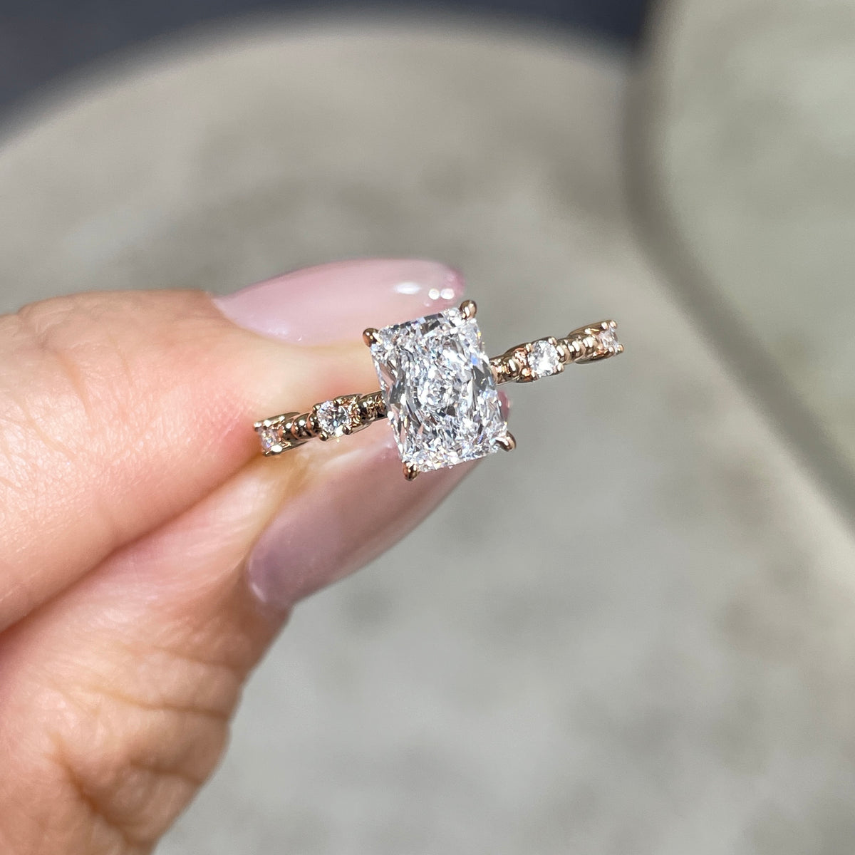 Lab Diamond radiant cut 1ct four-prong side stone with milgrain band ring