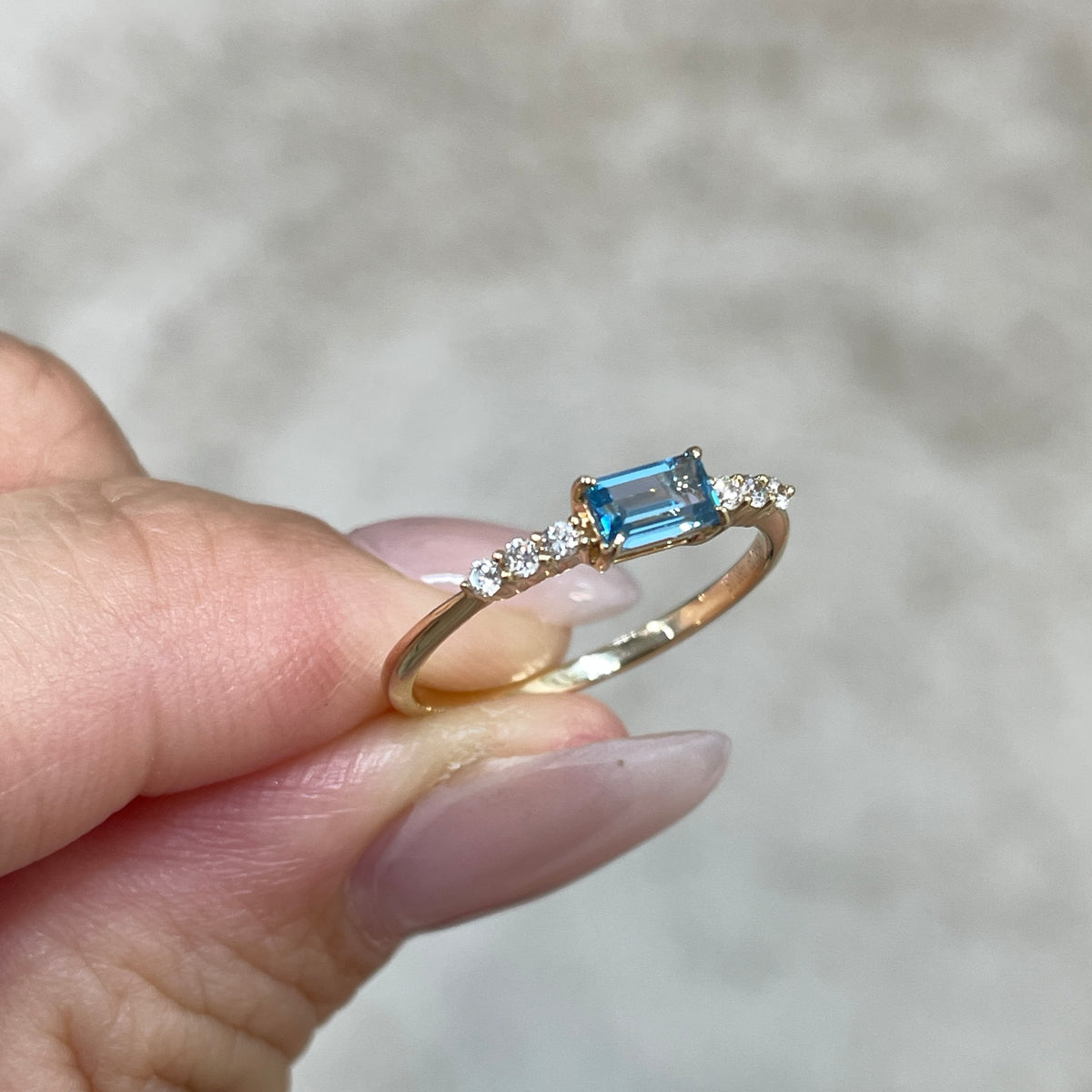 9k Lab sapphire aquamarine color baguette cut 0.35ct four-prong side stone ring