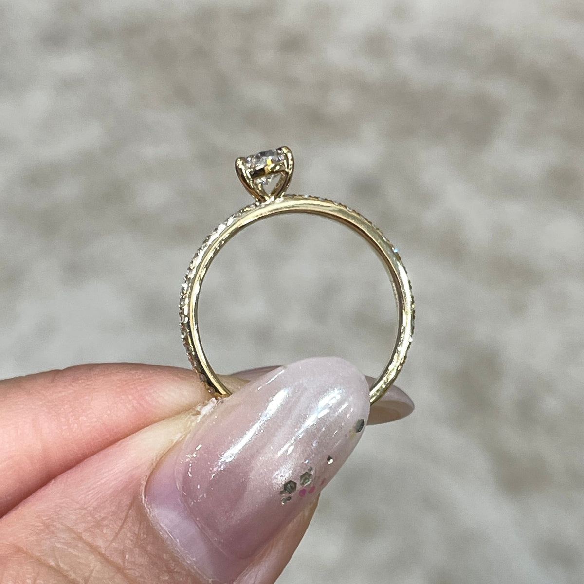 9k Lab diamond pear 0.6ct three-prong ¾ coverage pave ring
