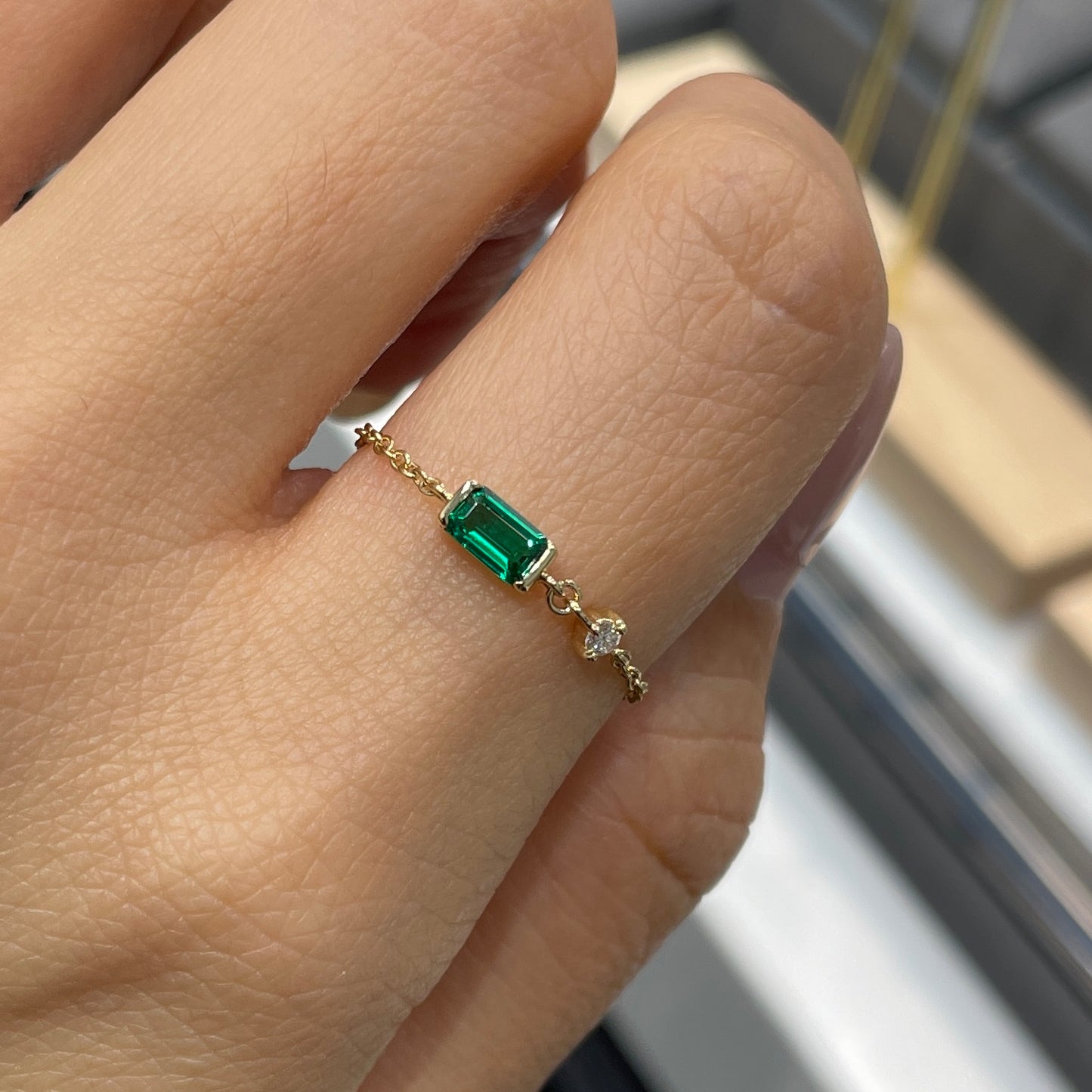 Lab Grown Emerald half bezel with little diamond chain ring