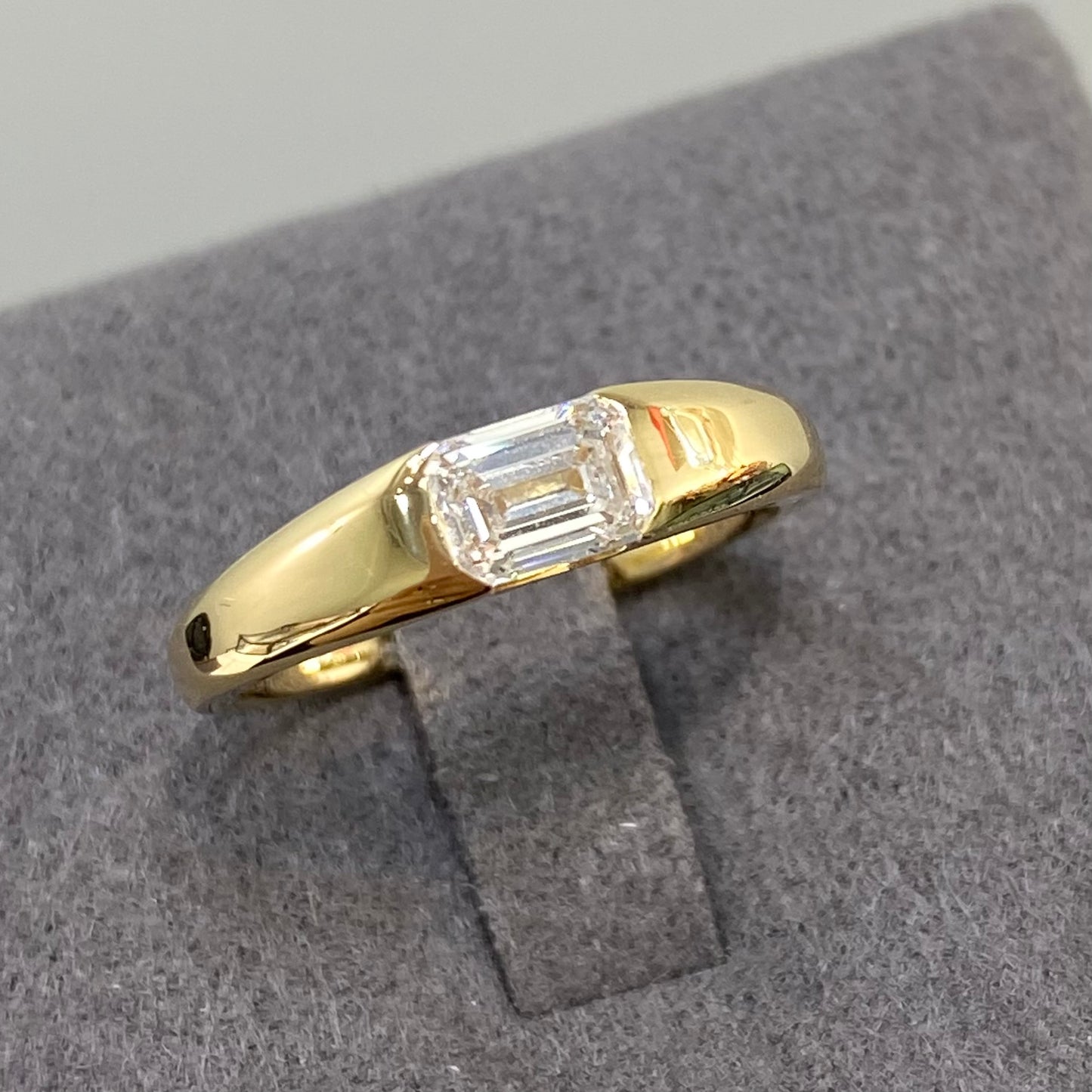 IGI Lab diamond emerald cut 0.6ct east west horizontal ring