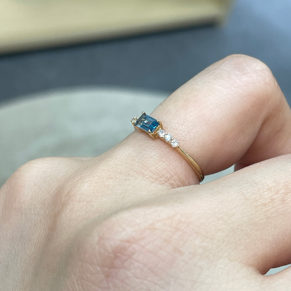 9k Lab sapphire aquamarine color baguette cut 0.35ct four-prong side stone ring