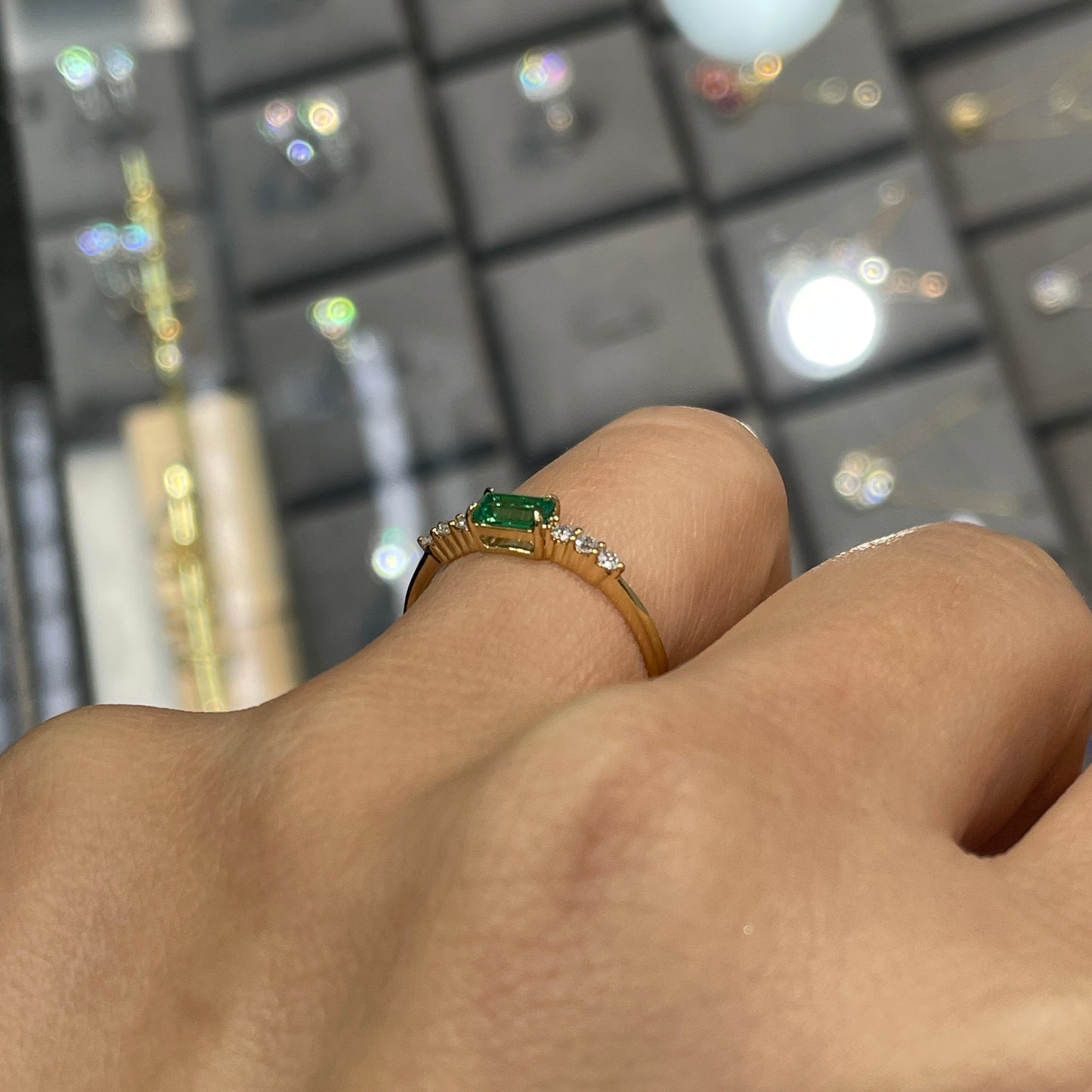 Lab Emerald baguette cut 0.35ct four-prong side stone ring